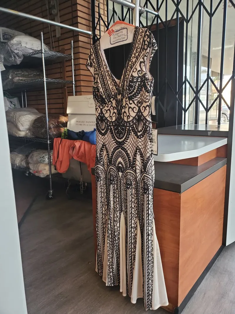 A beaded gown hanging by the counter