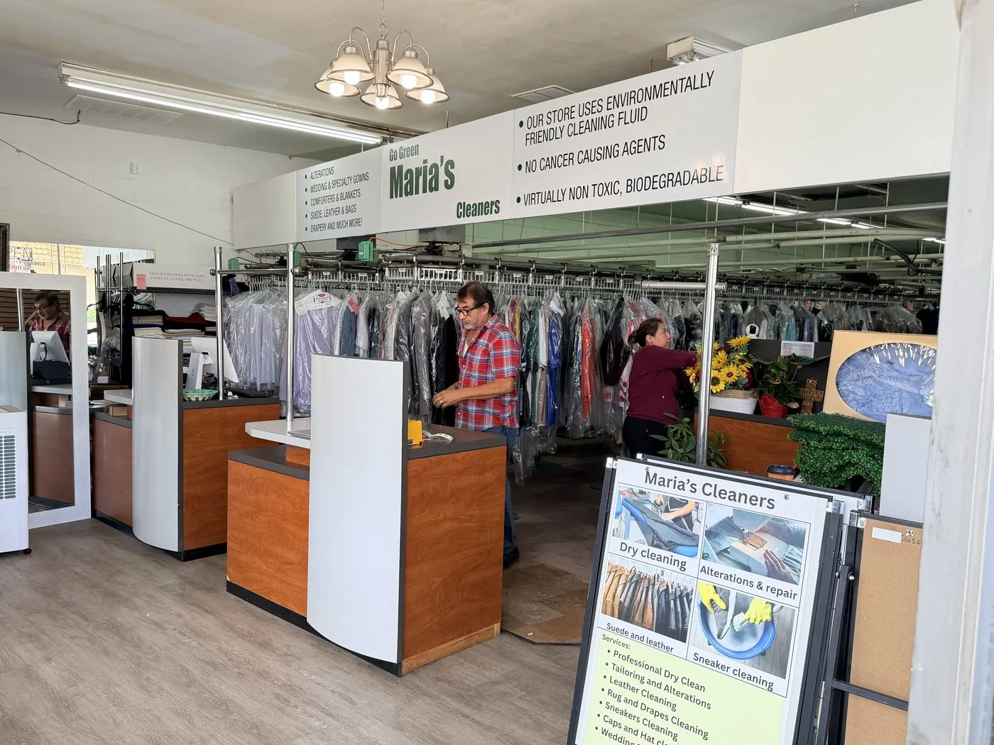 Inside Maria's Cleaners, with the Go Green sign above the front counter